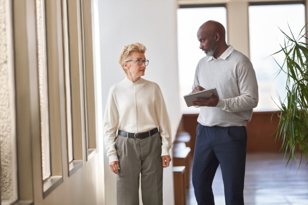 Chief Human Resource Officer (CHRO) and Chief Information Officer (CIO) talking in a hallway