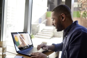 Male business professional speaking to a colleague via Teams using Windows Virtual Desktop.